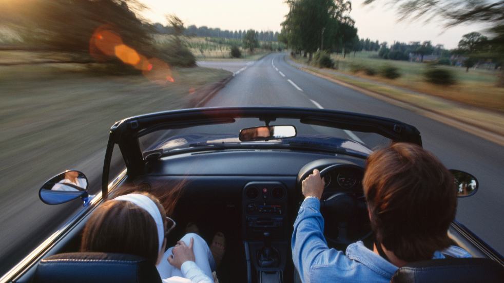 Couple driving soft top